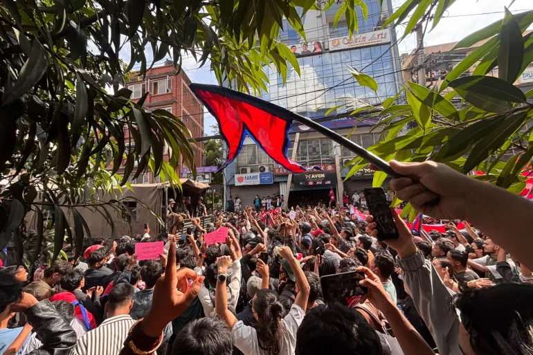 Nepal Gen Z protesters marching with placards demanding unban of social media and end to corruption.