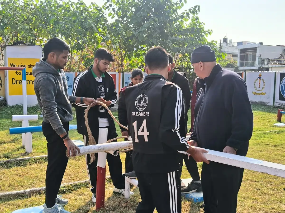 Best NDA Coaching Institute in Dehradun — Syllabus, Fees, Batches Group of trainees collaborating on a physical team task with equipment under instructor supervision.