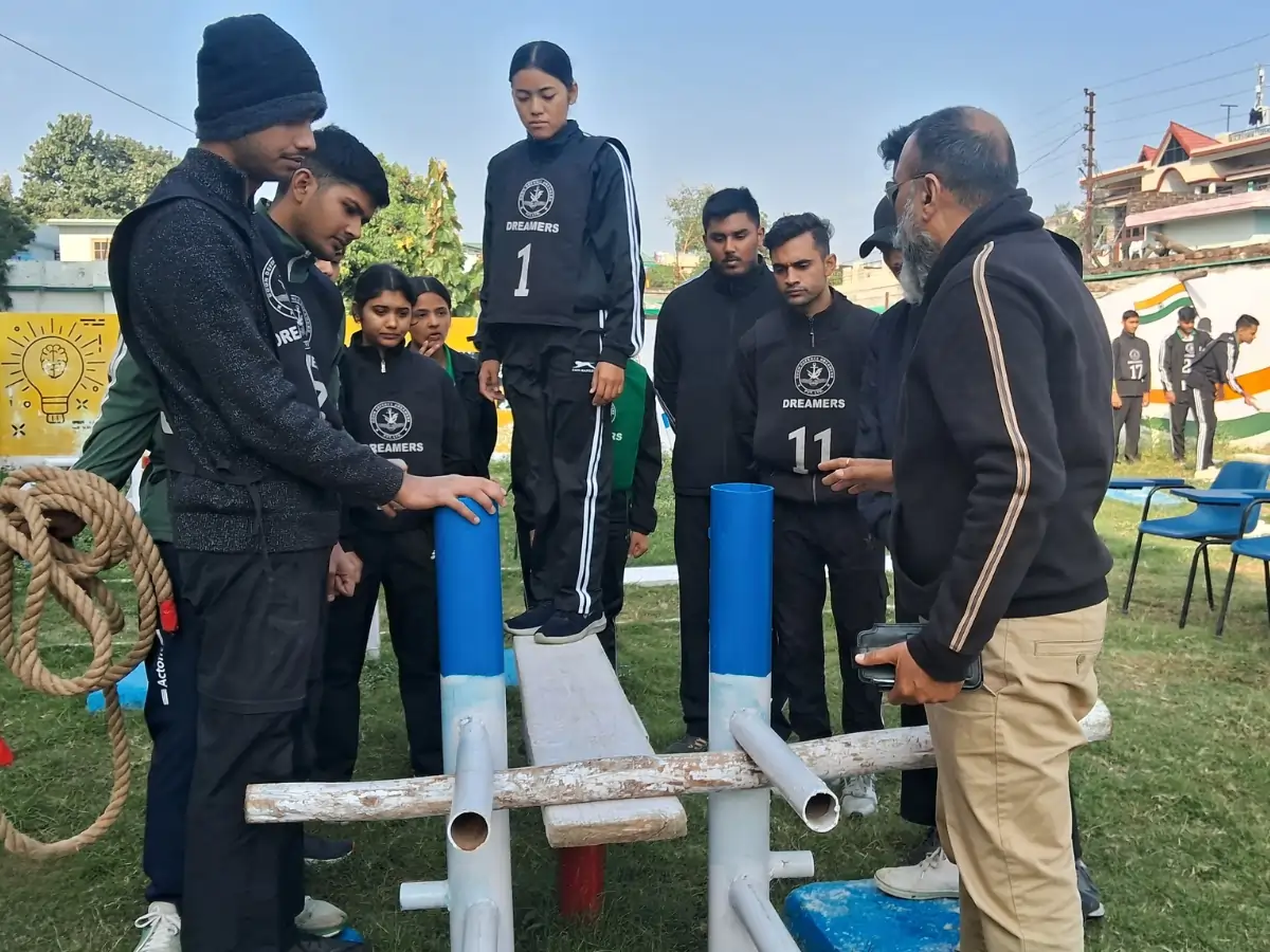 Best NDA Coaching Institute in Dehradun — Syllabus, Fees, Batches Students performing a balance and coordination task on training equipment while an instructor guides them.