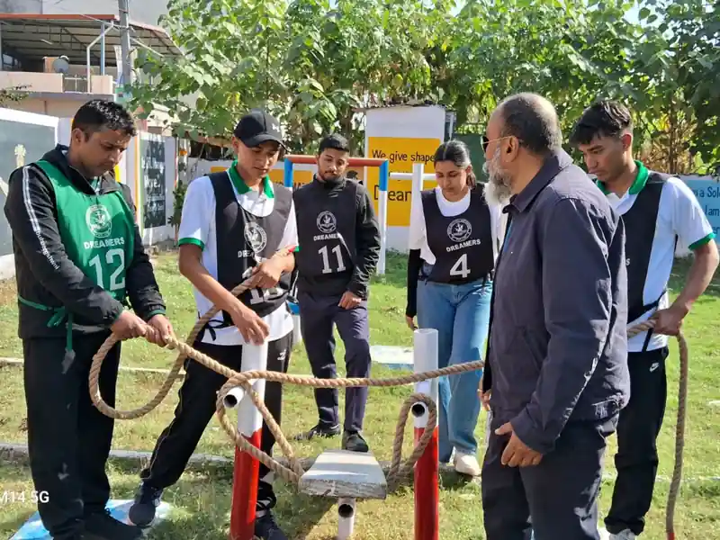 SSB candidates performing group obstacle task with rope under mentor guidance during SSB training session at Dreamers Edu Hub.